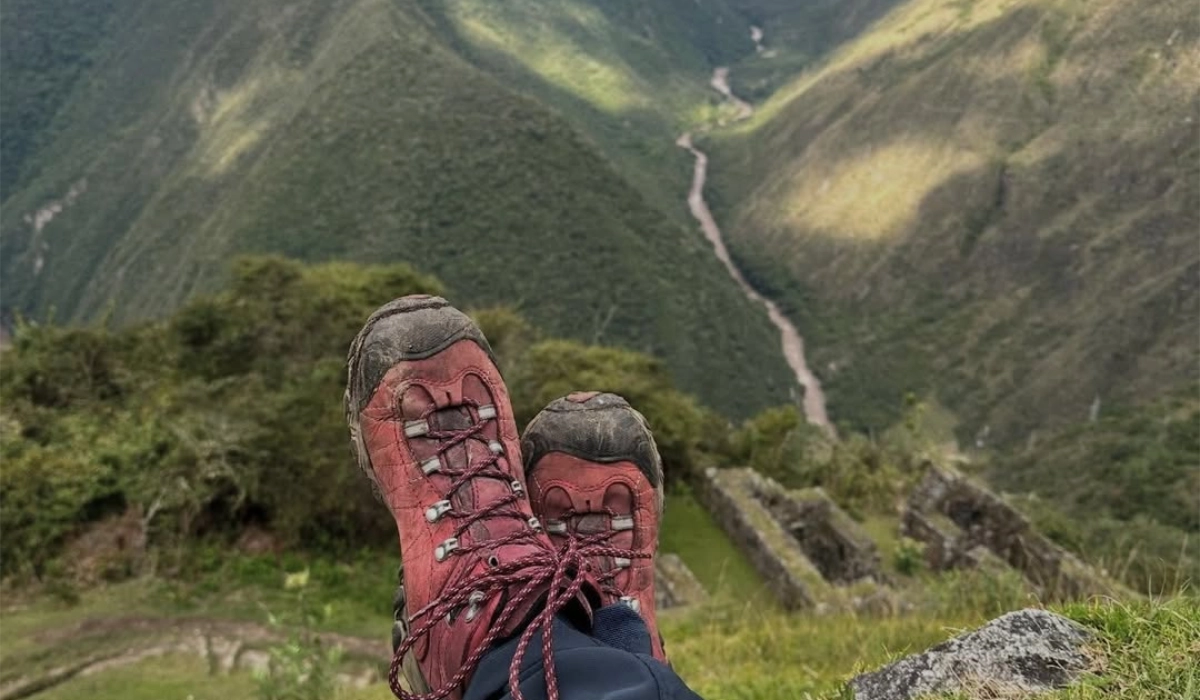 Hiking boots overlooking an Andean mountain valley