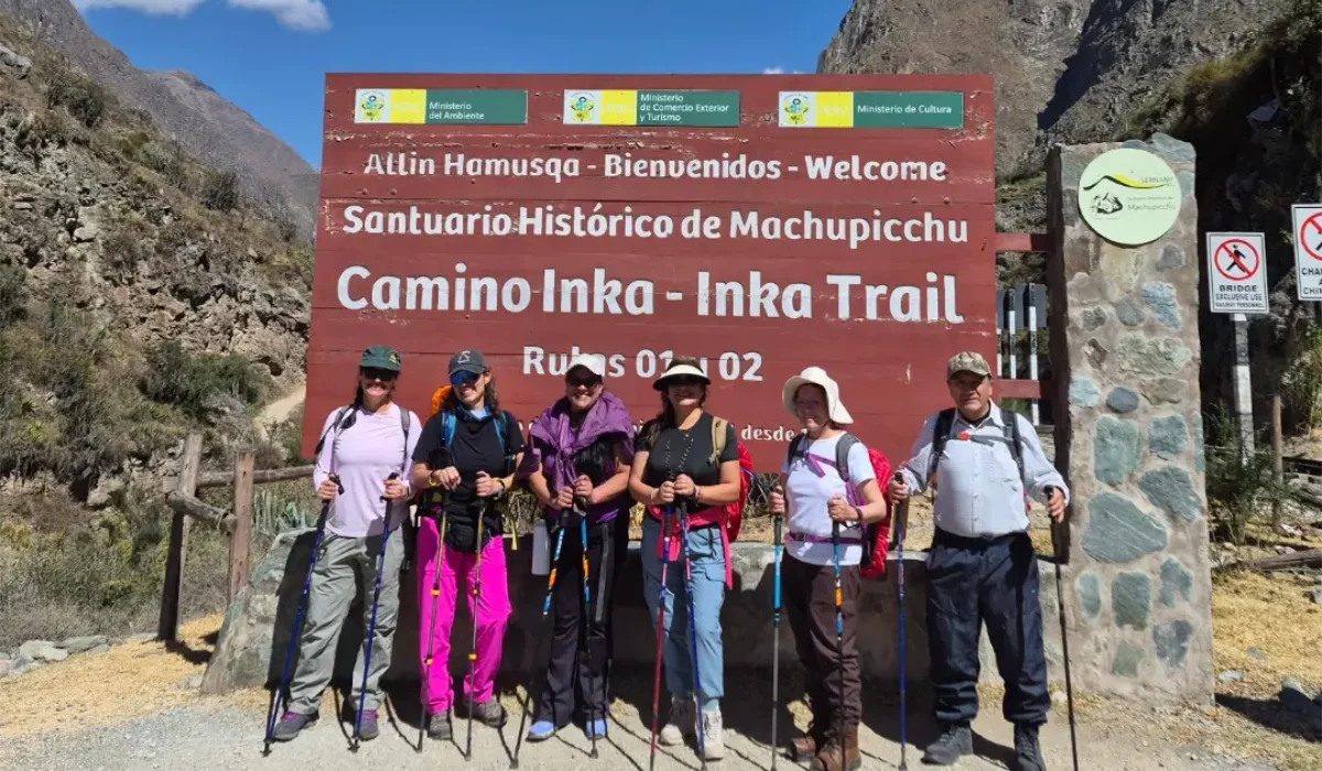 Tourists posing at the official Inca Trail starting point