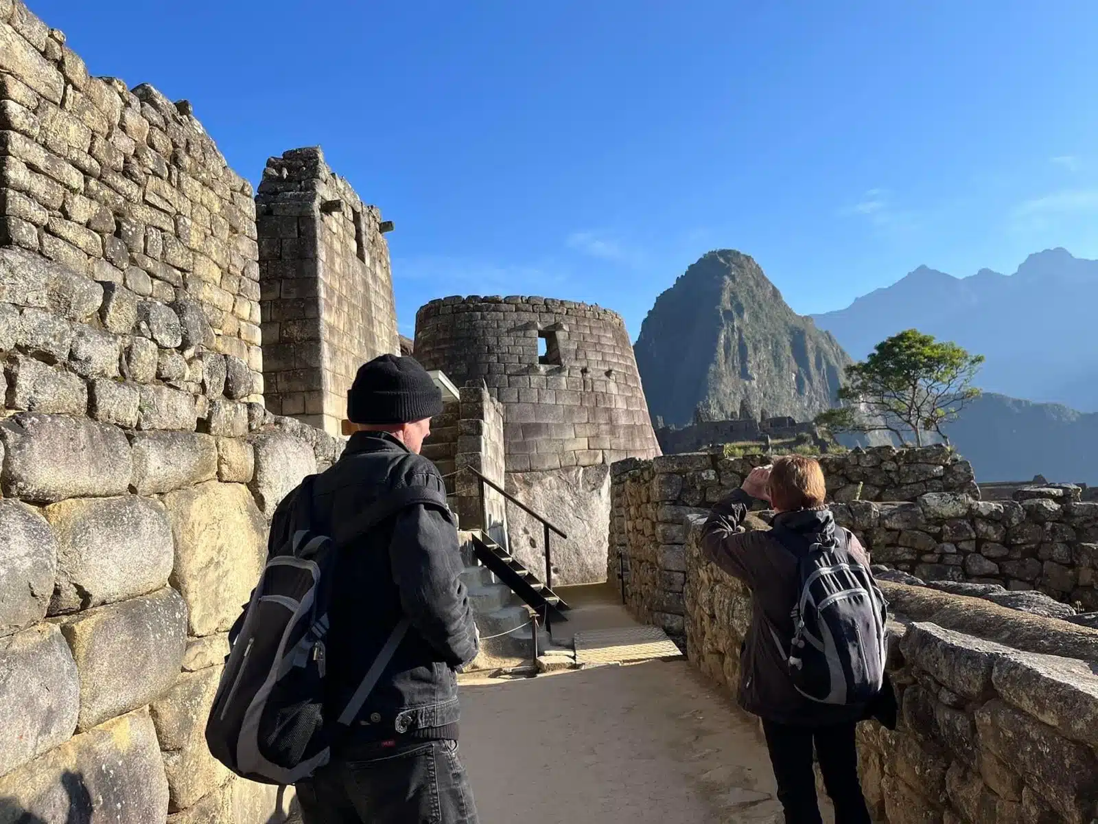 Travelers exploring Machu Picchu during sunrise