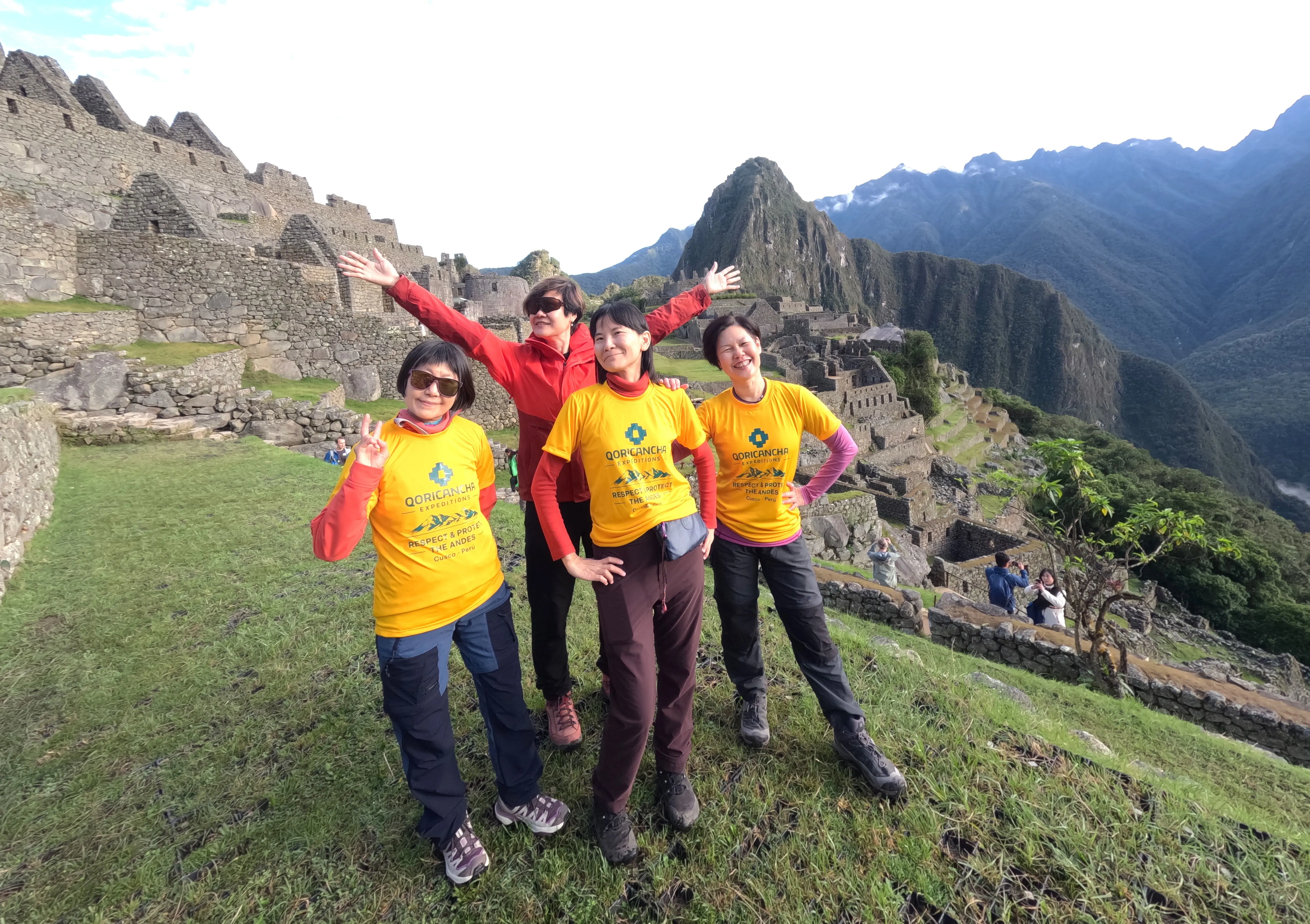 Happy travelers at Machu Picchu on Day 4 of the luxury Inca Trail | Qoricancha Expeditions