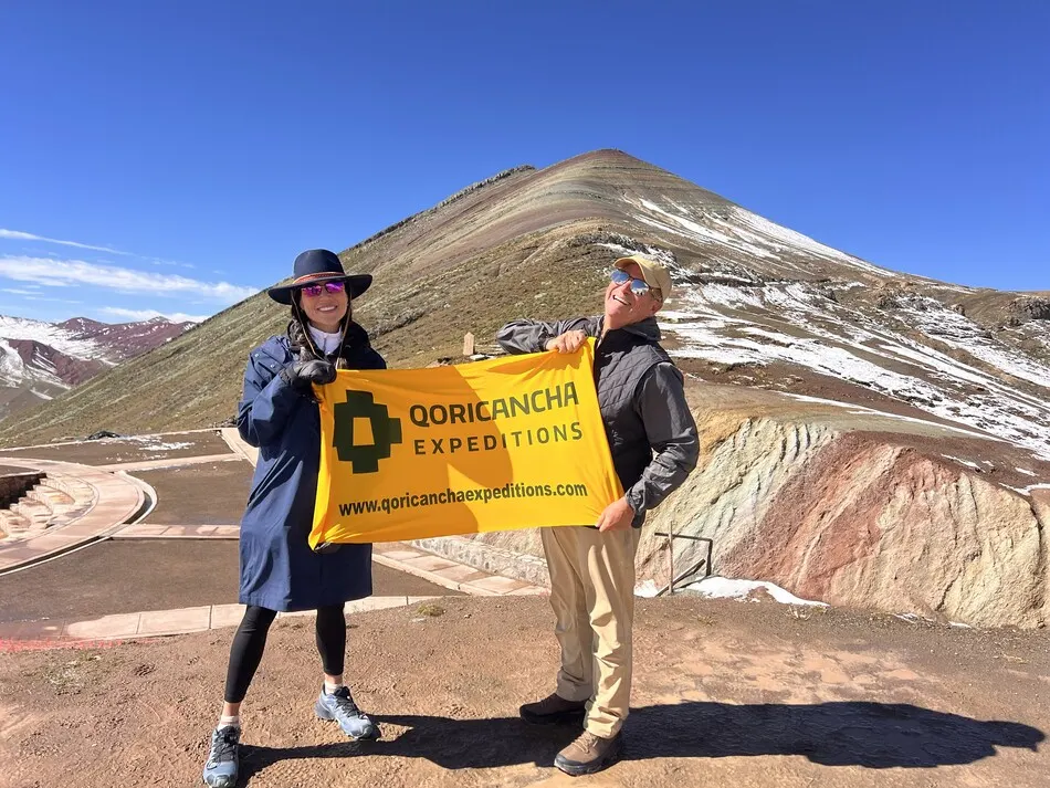 Travelers reaching a scenic viewpoint on the Ausangate Trek
